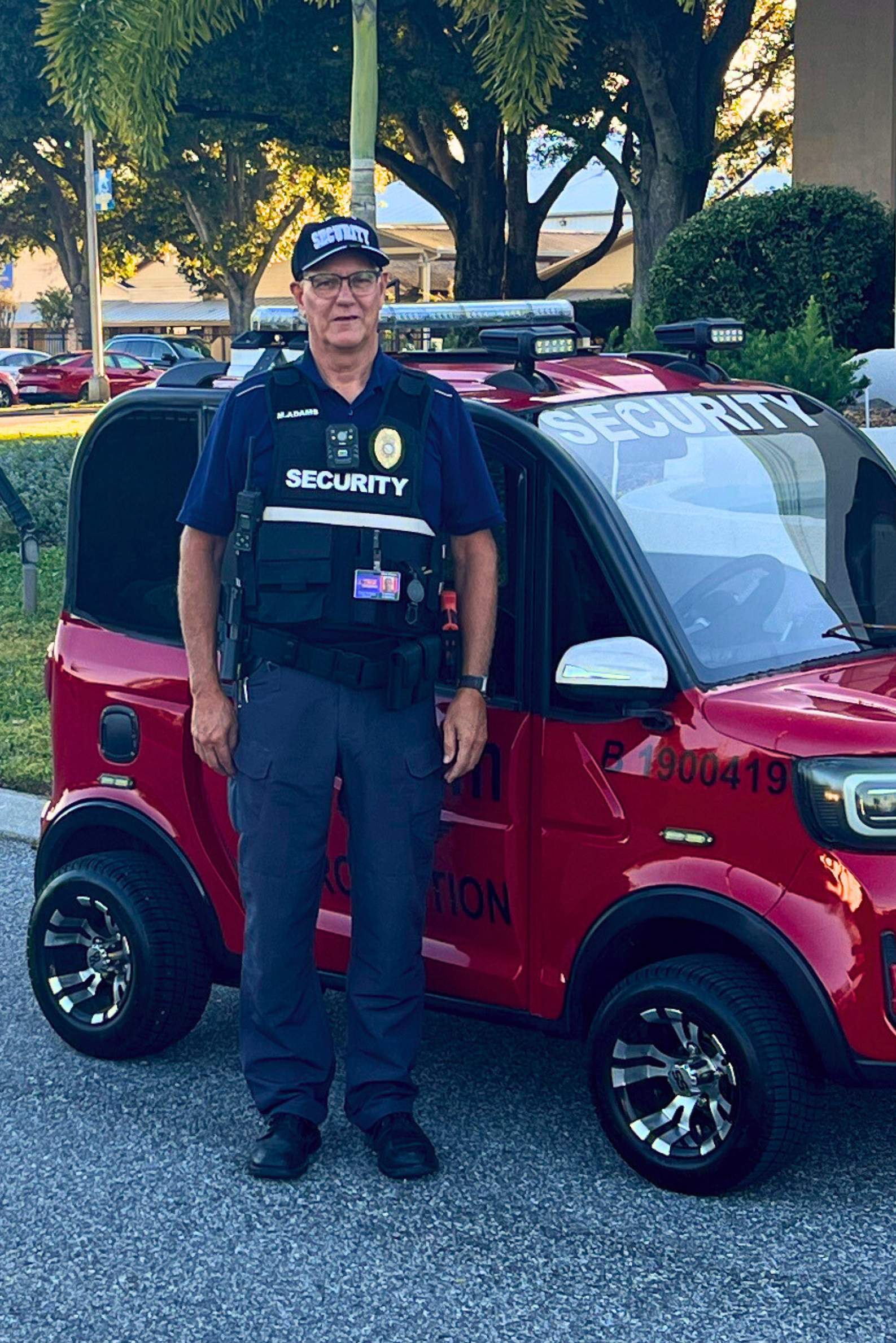 Man in security uniform standing in front of a building.