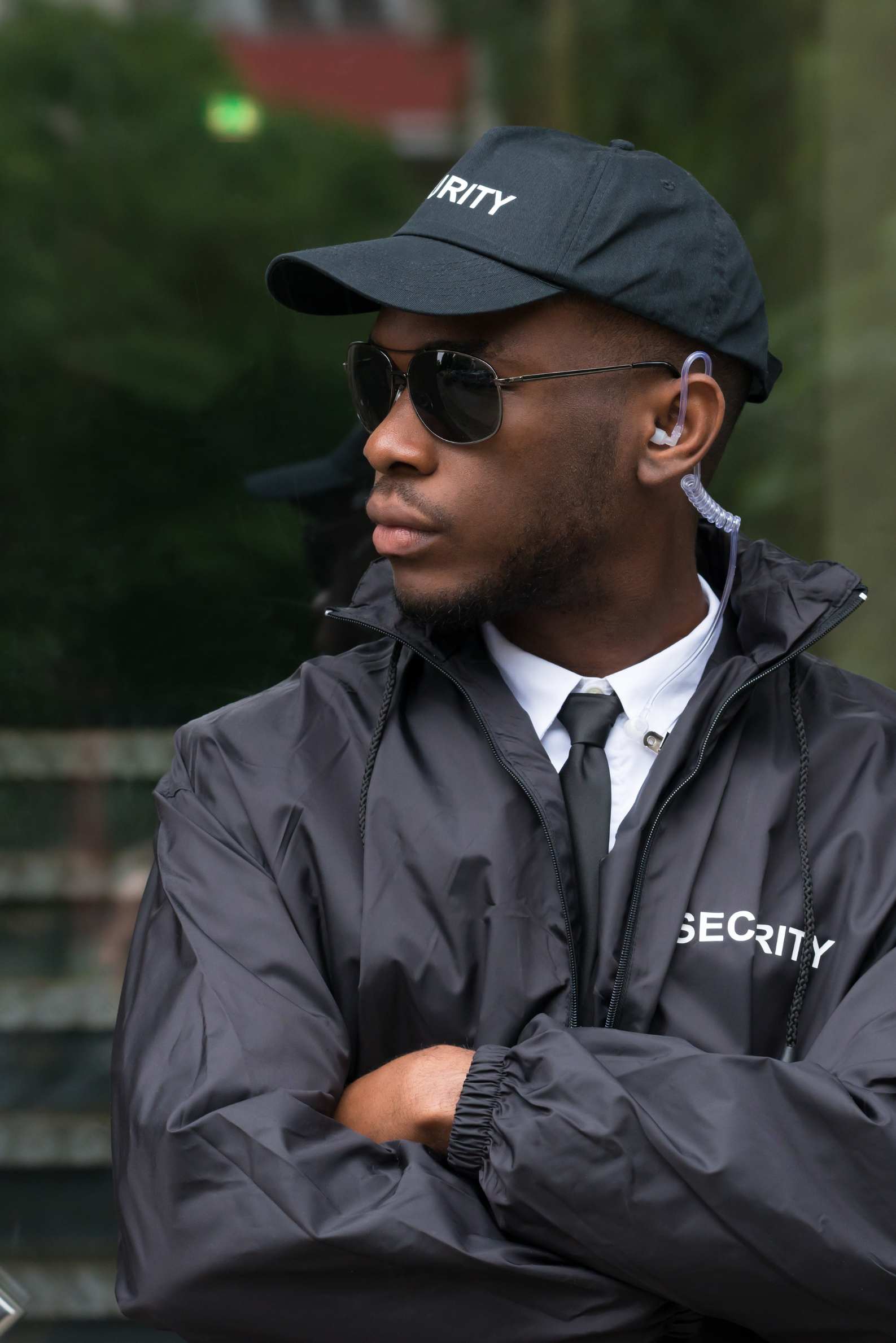 Man in security uniform standing in front of a building.