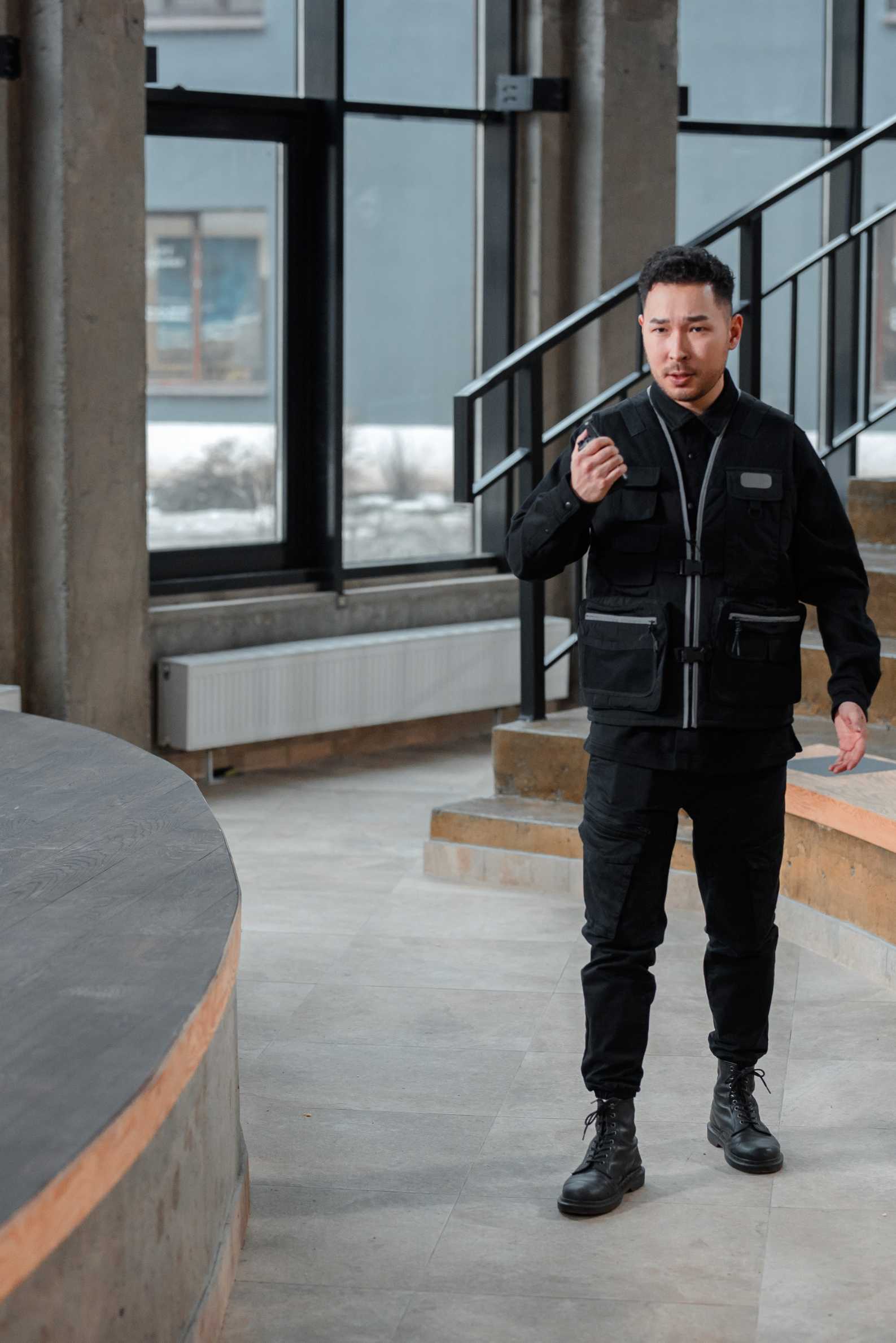 Man in security uniform standing in front of a building.